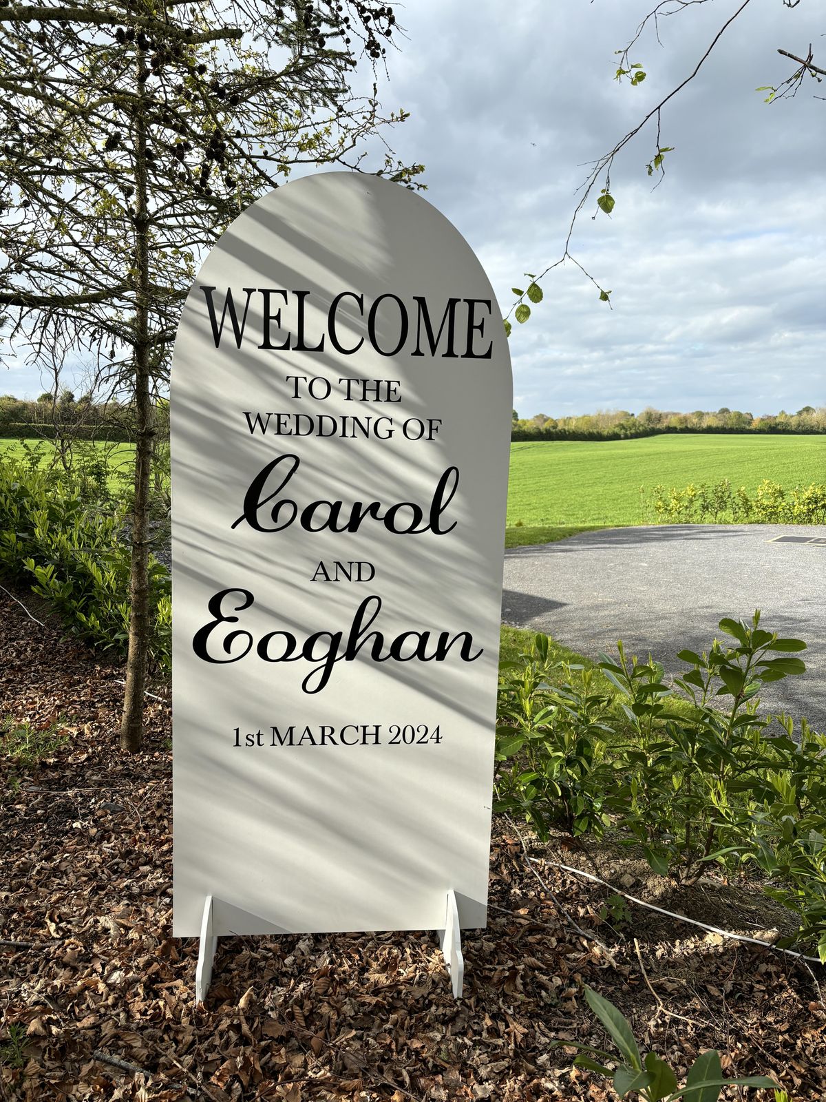Oval welcome sign with greenery