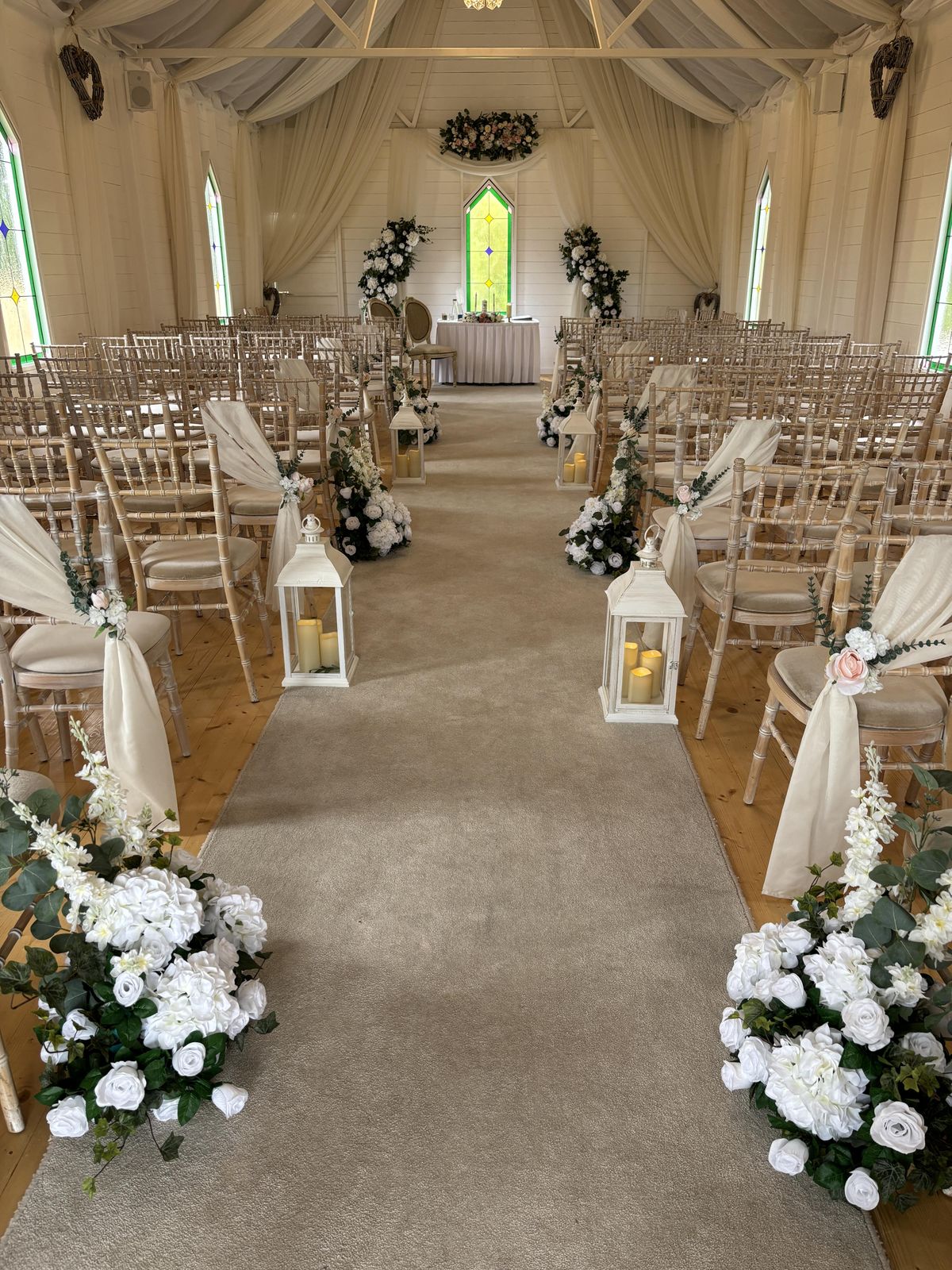 Meadow flowers and lanterns ceremony aisle