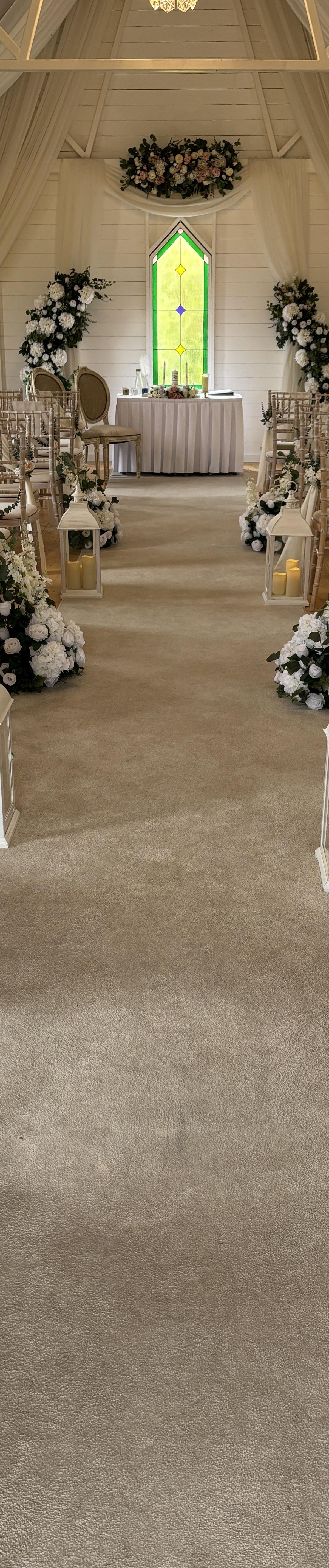 Meadow flowers and lanterns ceremony aisle
