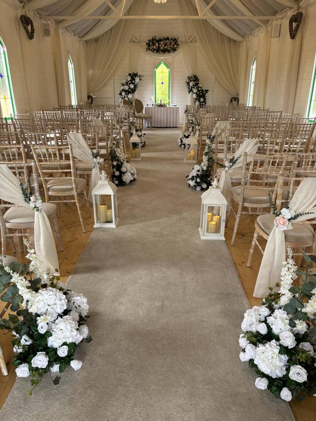 Meadow flowers and lanterns ceremony aisle