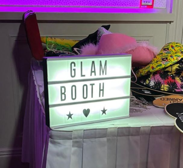 Photo booth neon sign strike a pose