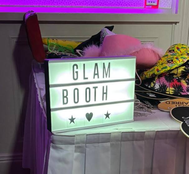 Photo booth neon sign strike a pose
