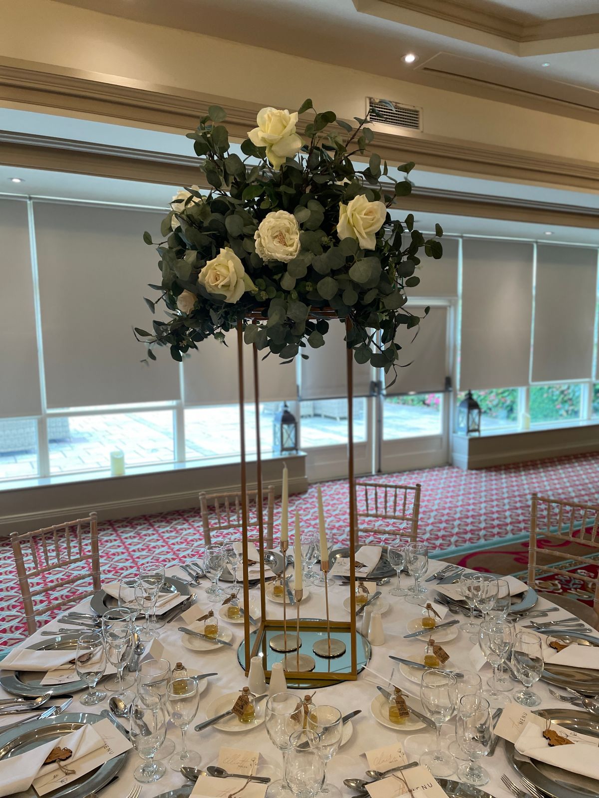Elegant table centrepiece with flowers and candles