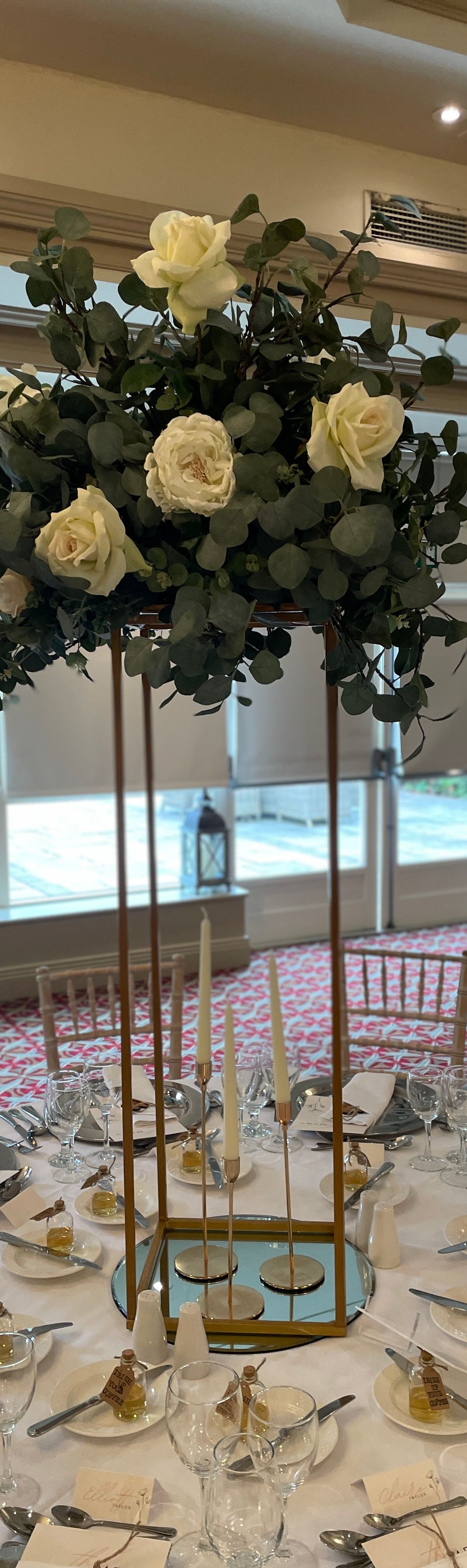 Elegant table centrepiece with flowers and candles